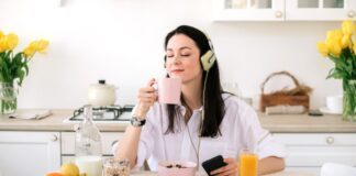 ragazza colazione beve tazza caffè ascolta musica