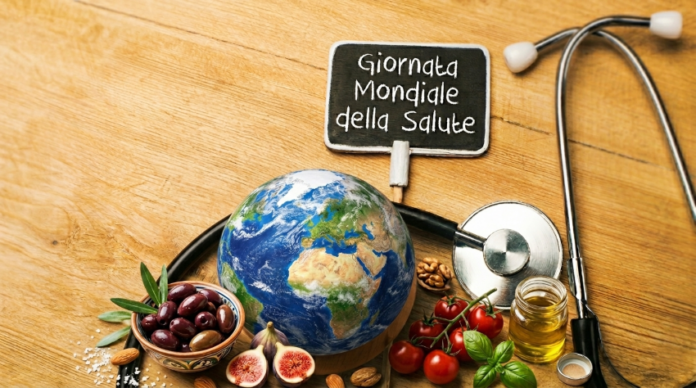 cibi tipici della dieta mediterranea e una scritta: giornata mondiale della salute